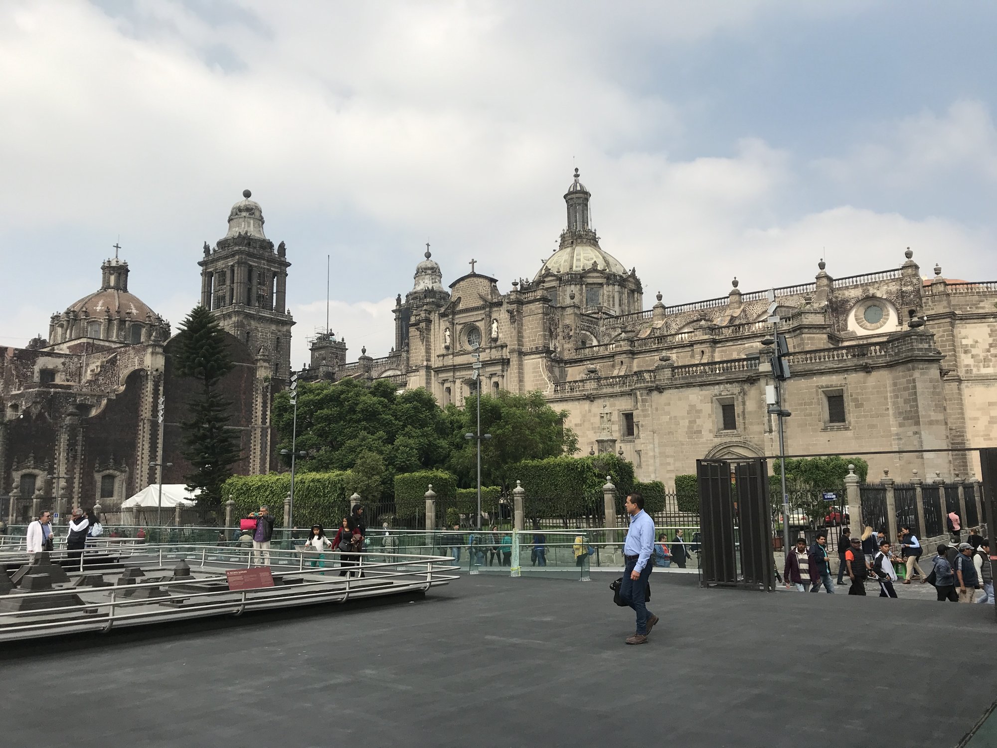 The Catedral Metropolitana&rsquo;s stone façade and towers seen across the open Zócalo under a pale sky