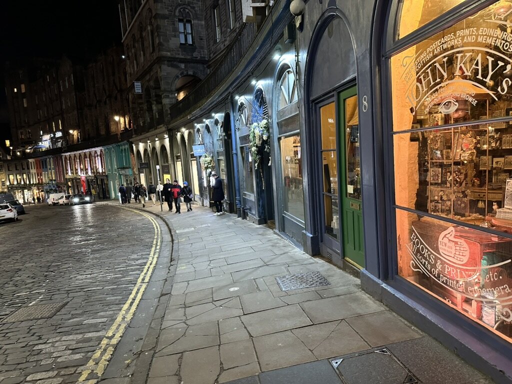 Victoria Street's curved, colorful shopfronts lit up at night