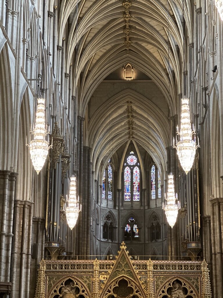 The soaring vaulted ceiling and chandeliers inside the nave of Westminster Abbey