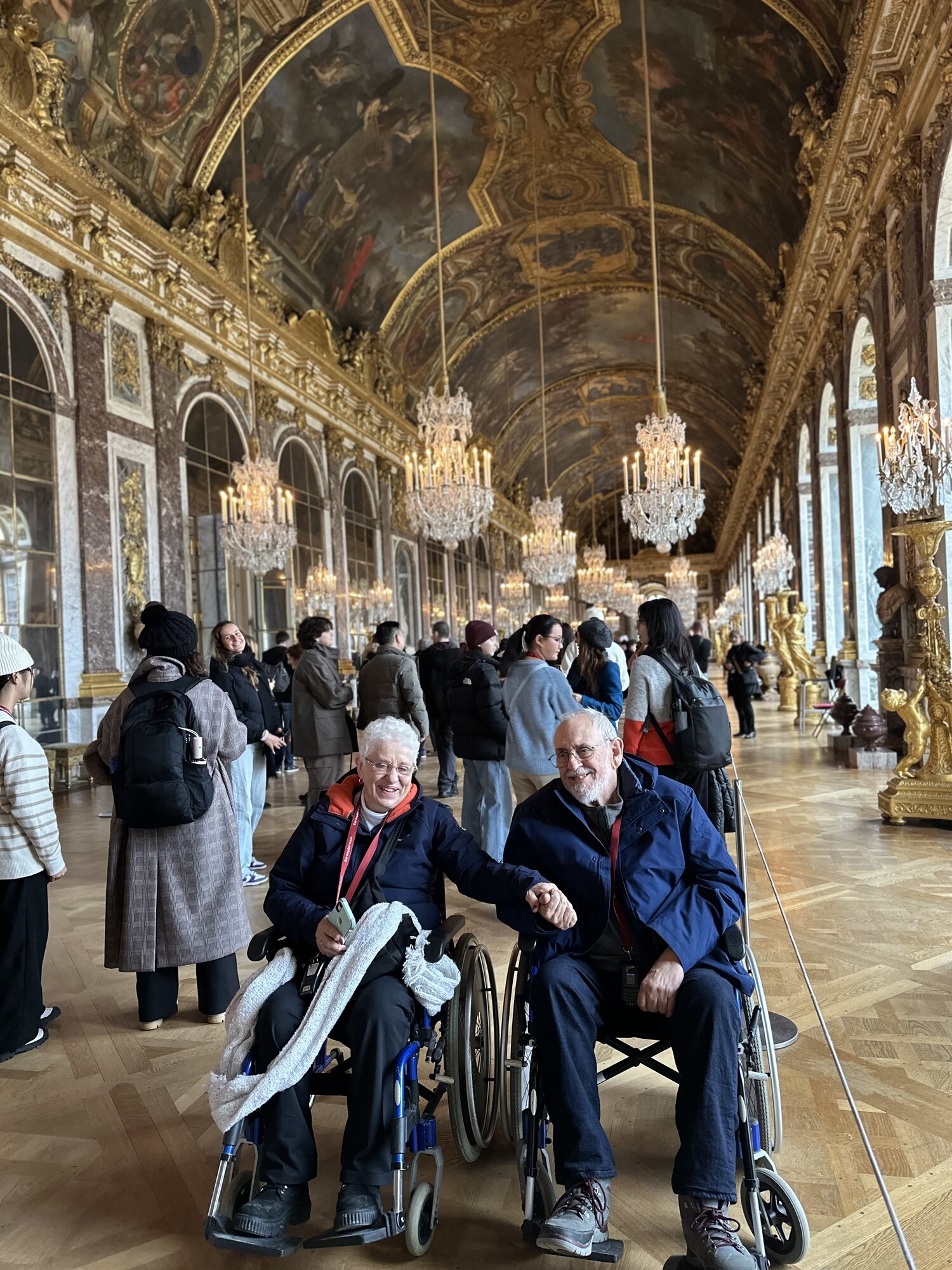 Mom and Dad in their wheelchairs in the Hall of Mirrors at Versailles