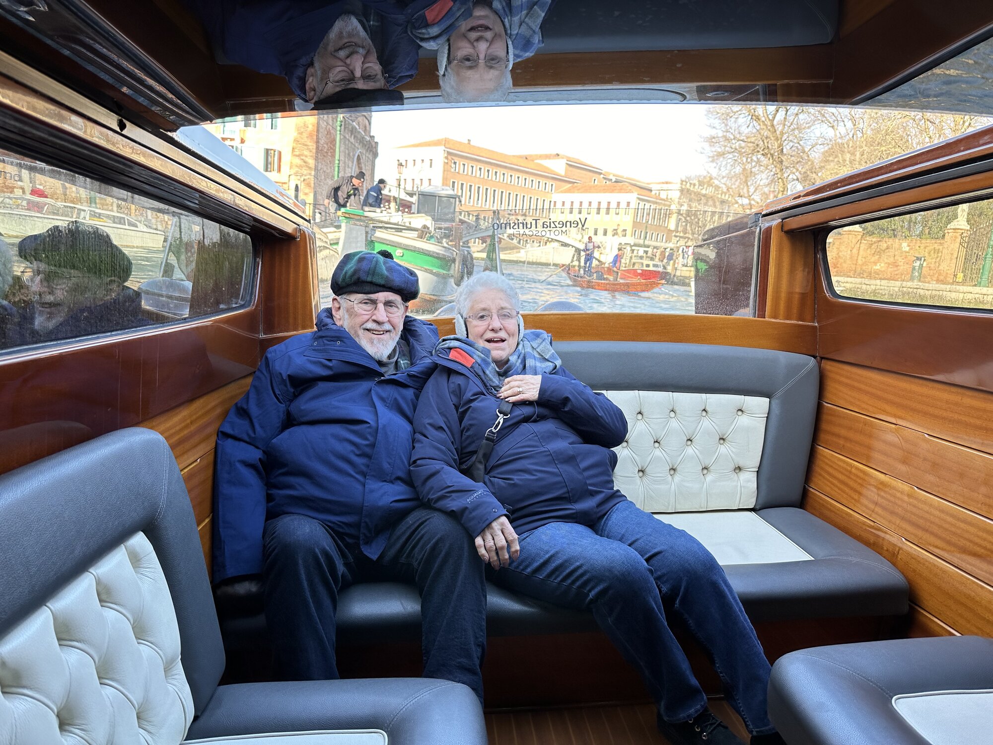 Mom and Dad relaxing inside the cabin of a private water taxi