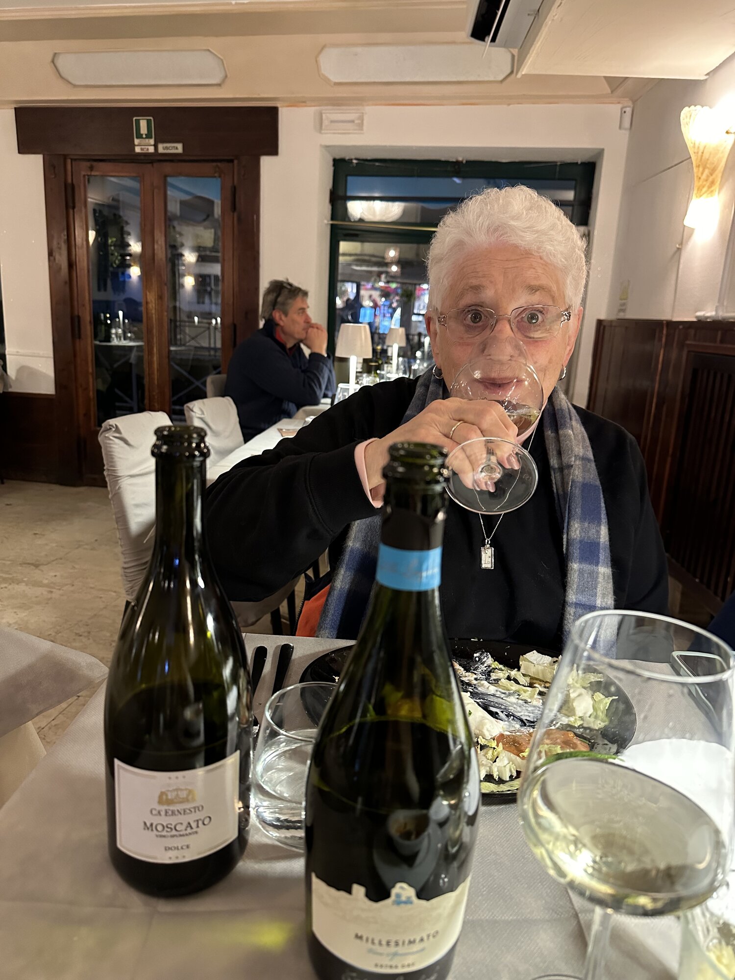Step-mom raising a glass of Prosecco at dinner