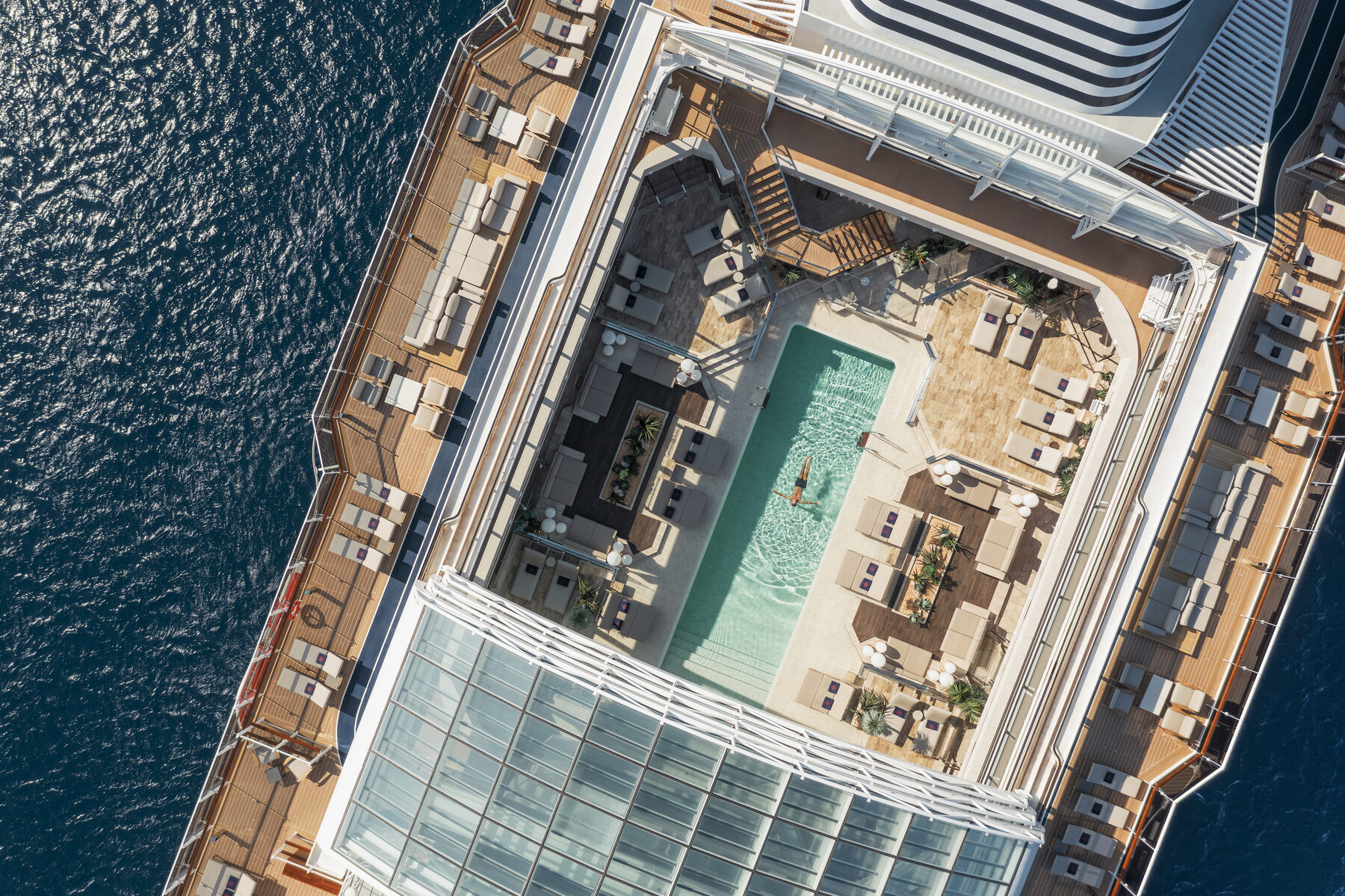 Explora media kit aerial view of the central pool deck and its glass-roofed section