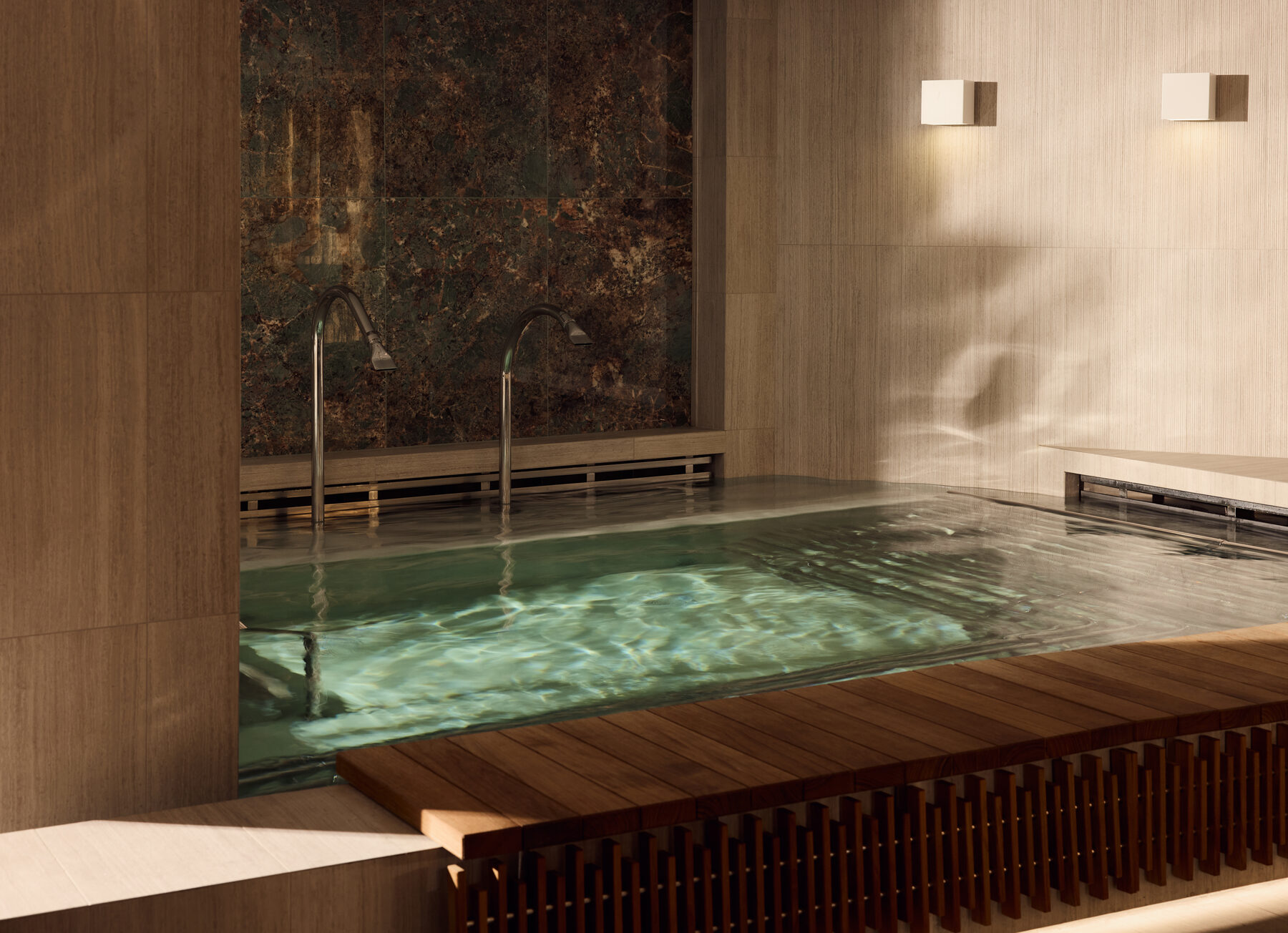 Explora media kit photo of the Ocean Wellness thalassotherapy pool, warm stone walls and a wooden step