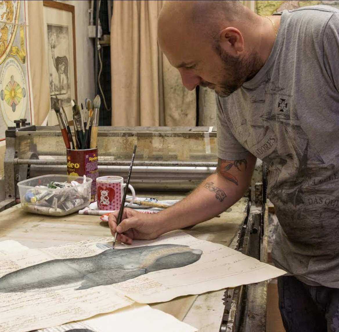 A Florentine printmaker hand-painting an engraving