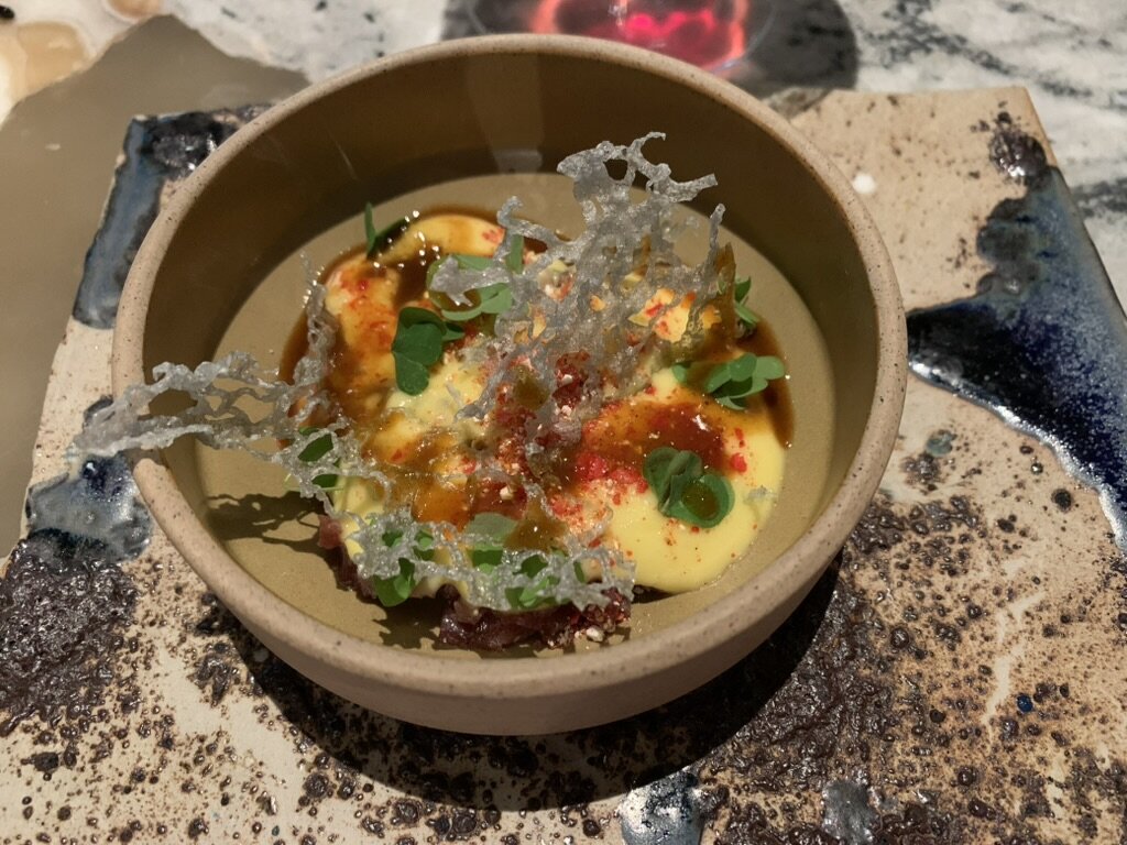 A Central course in a stoneware bowl with a spun-sugar garnish