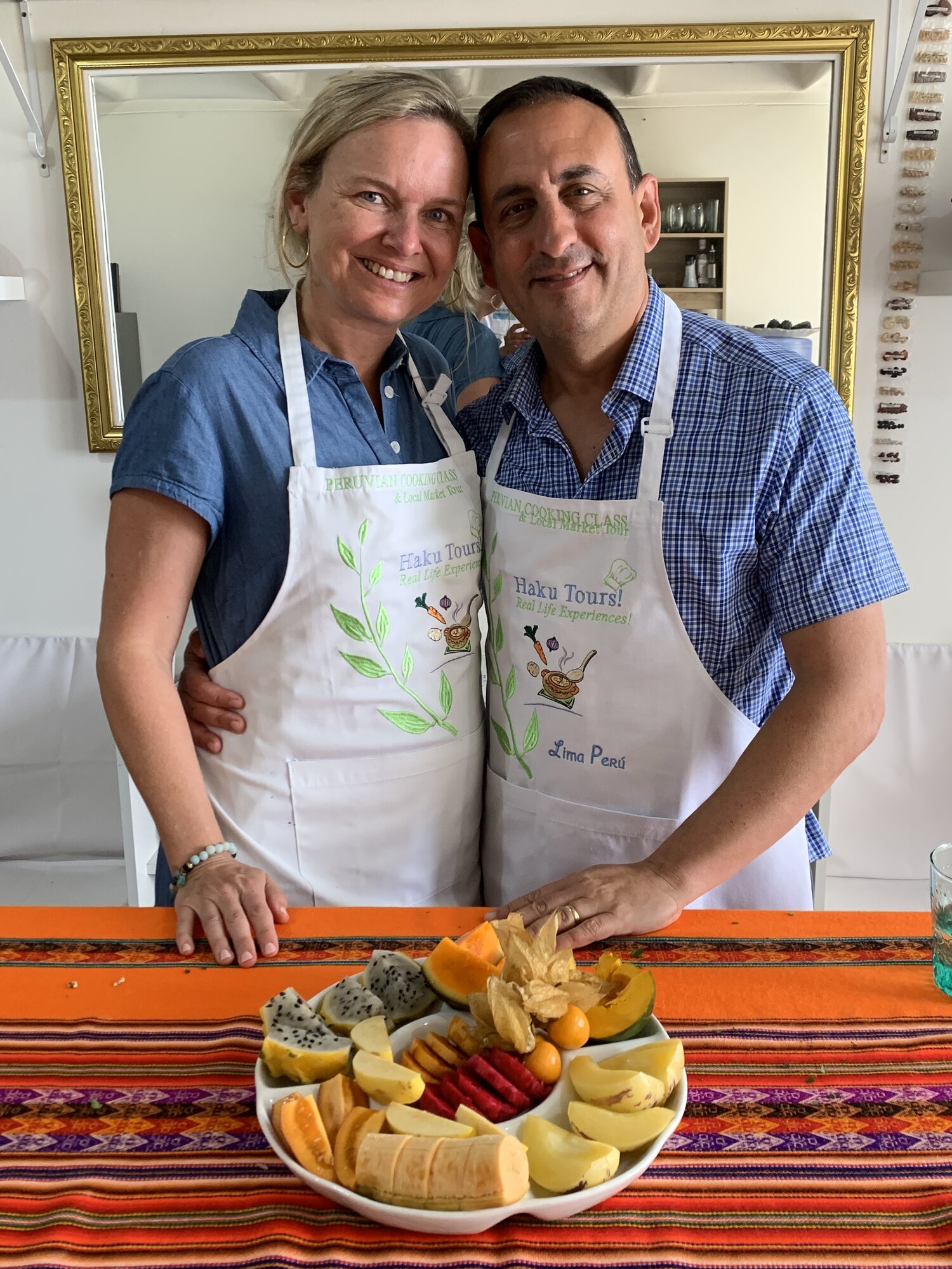 She-Stache and He-Stache in matching Haku Tours aprons at their Lima cooking class