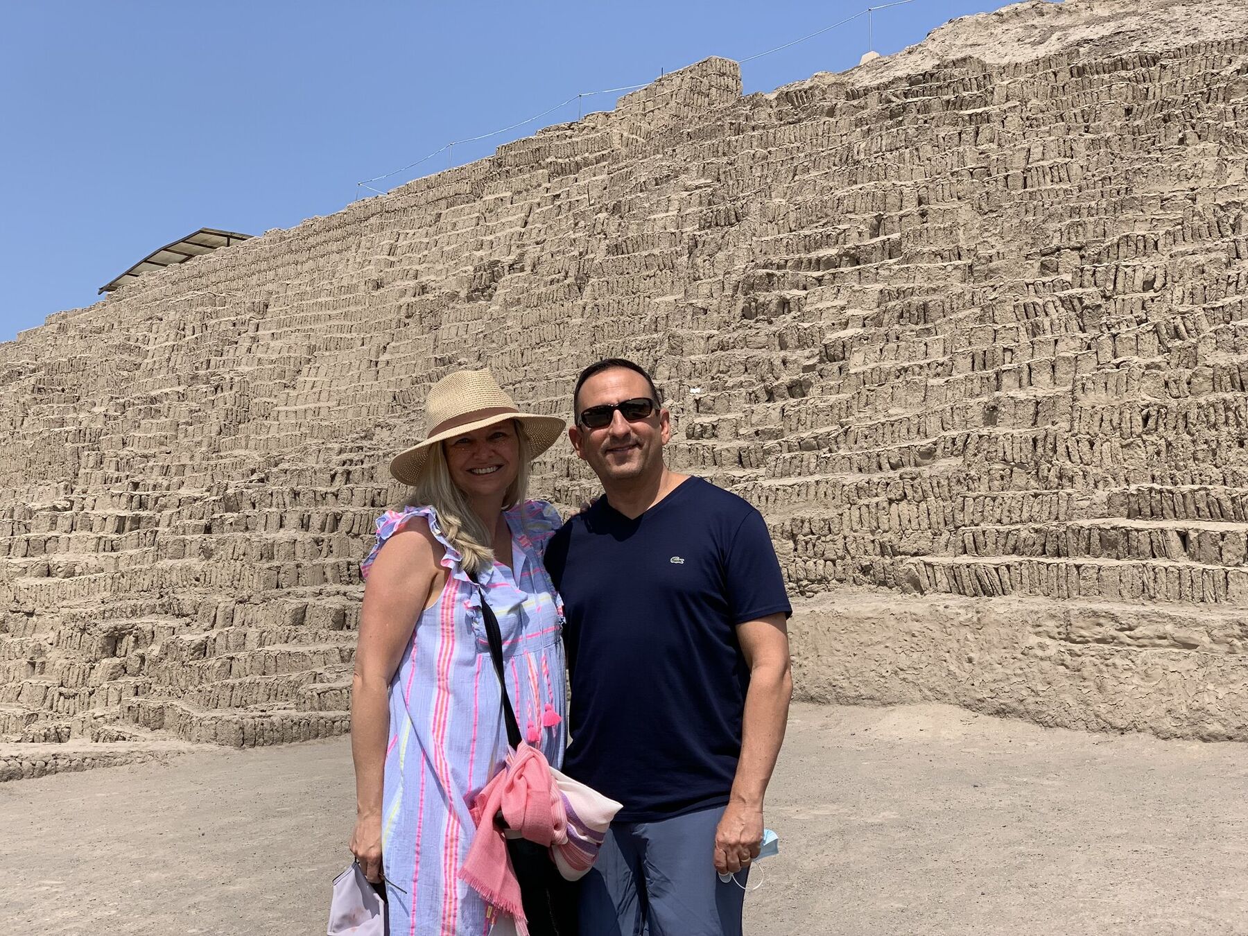She-Stache and He-Stache in front of the stepped adobe pyramid of Huaca Pucllana in Miraflores