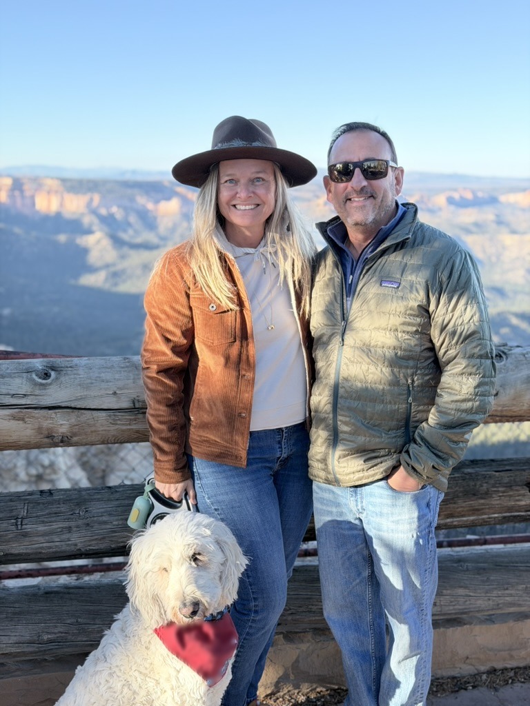 She-Stache, He-Stache and Pup-Stache on leash at a wooden railing above the hoodoos of Bryce Canyon
