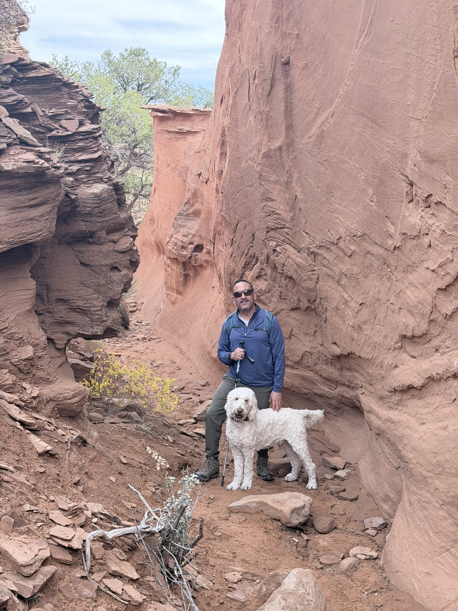 He-Stache standing with Pup-Stache in a narrow red sandstone canyon at Kodachrome Basin