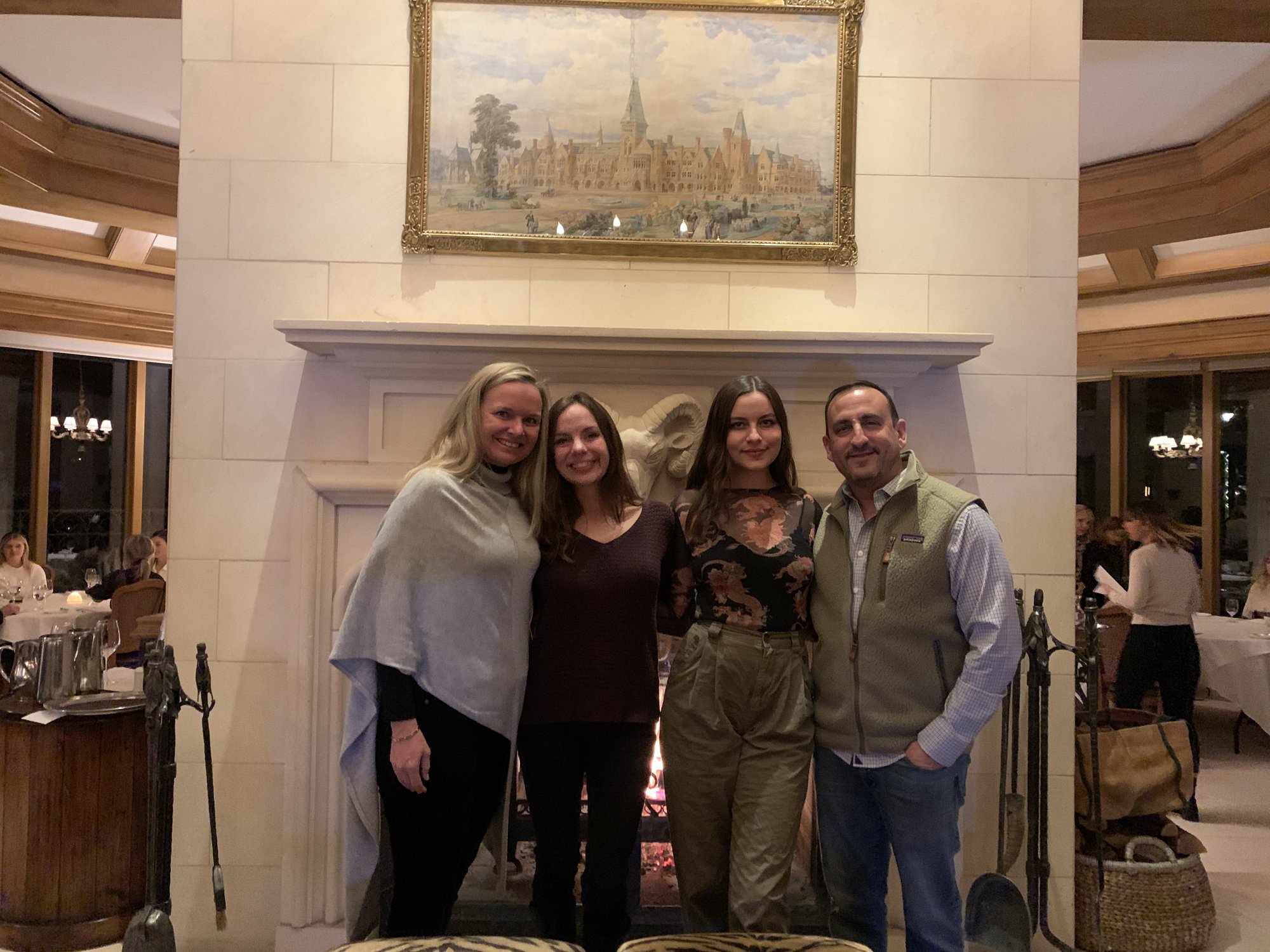 She-Stache, the Wee-Staches and He-Stache standing in front of a carved stone fireplace at Splendido