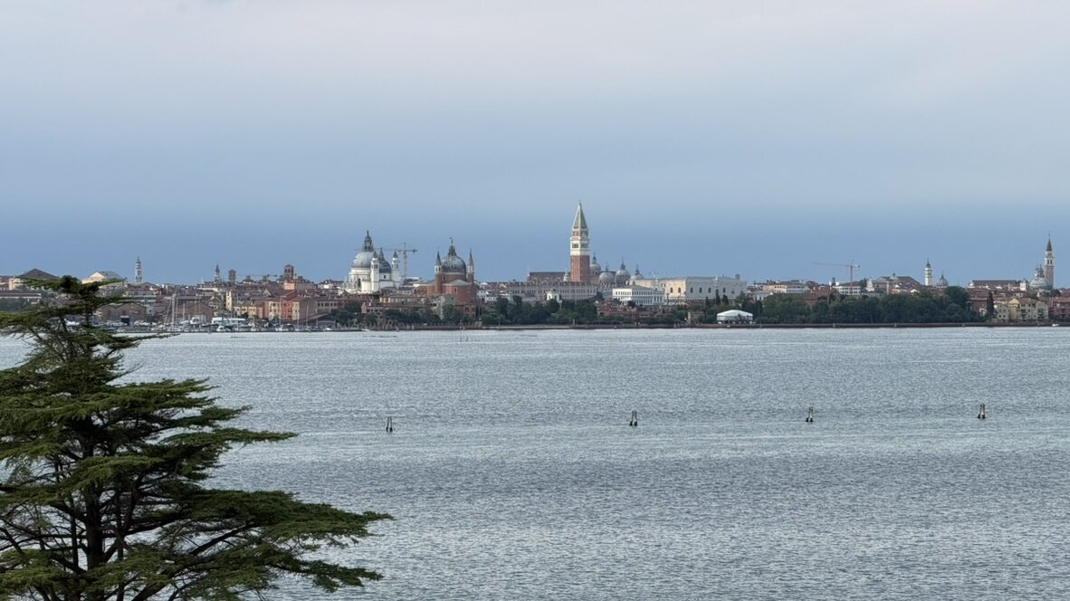 The Venice skyline and bell towers seen across the lagoon from the hotel island in the evening